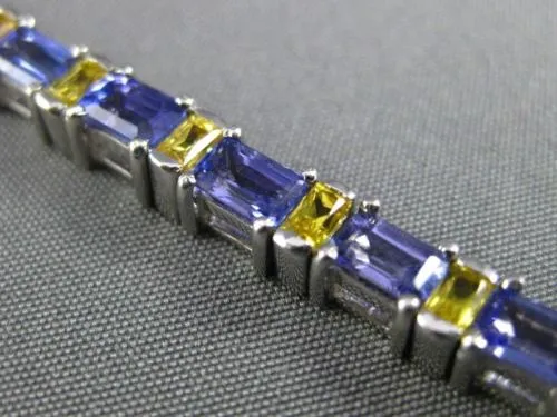 ESTATE WIDE 7.04CT TANZANITE & YELLOW SAPPHIRE 18KT WHITE GOLD TENNIS BRACELET