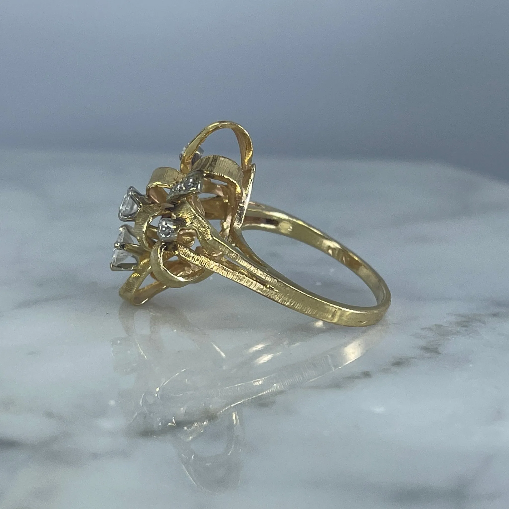 Vintage Diamond Cluster Ring with Old Hollywood Glamour. 14K Yellow Gold Setting with a Ribbon Design.