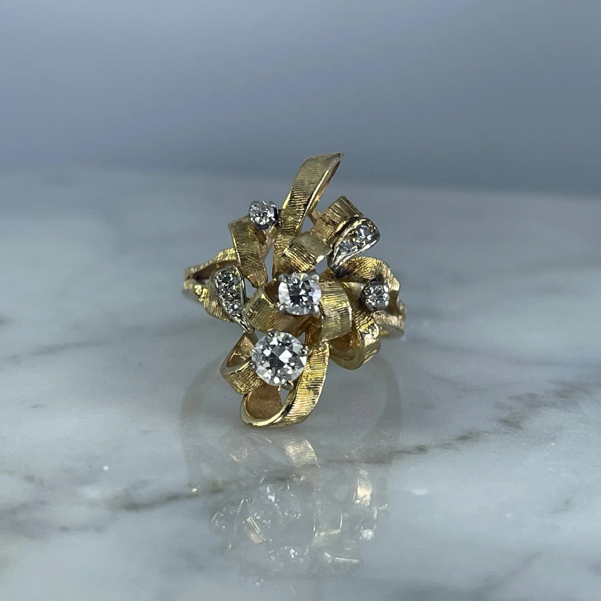 Vintage Diamond Cluster Ring with Old Hollywood Glamour. 14K Yellow Gold Setting with a Ribbon Design.