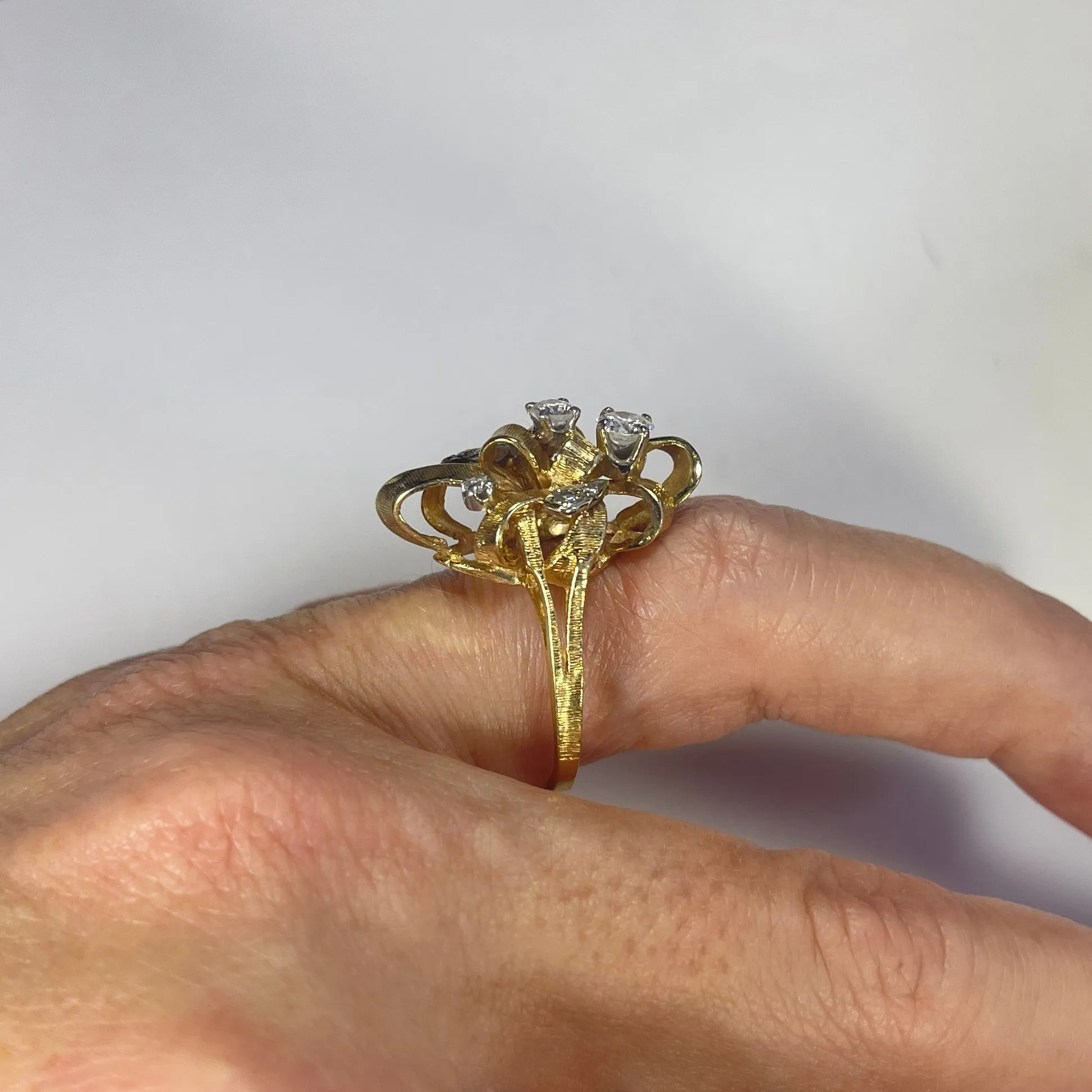 Vintage Diamond Cluster Ring with Old Hollywood Glamour. 14K Yellow Gold Setting with a Ribbon Design.