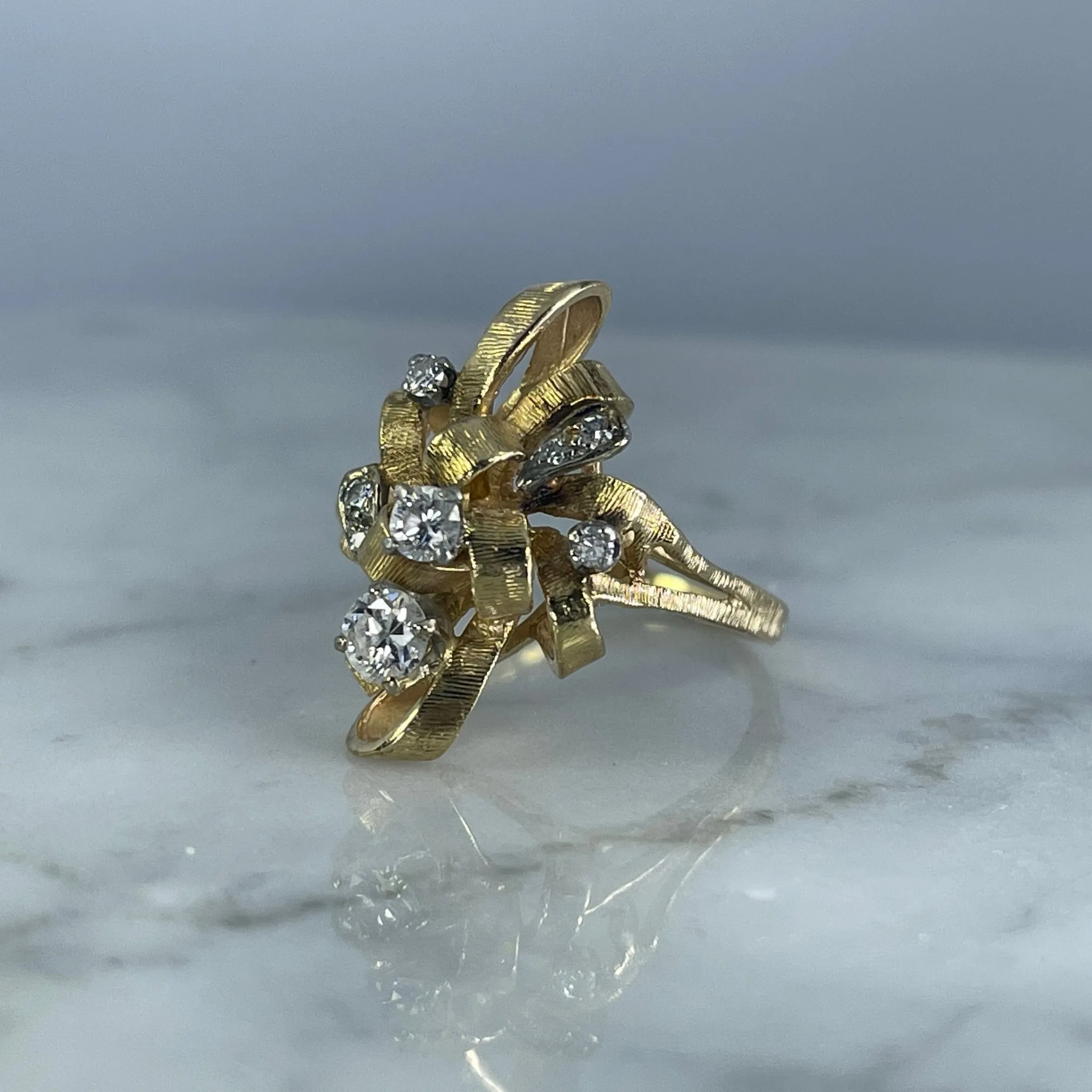 Vintage Diamond Cluster Ring with Old Hollywood Glamour. 14K Yellow Gold Setting with a Ribbon Design.