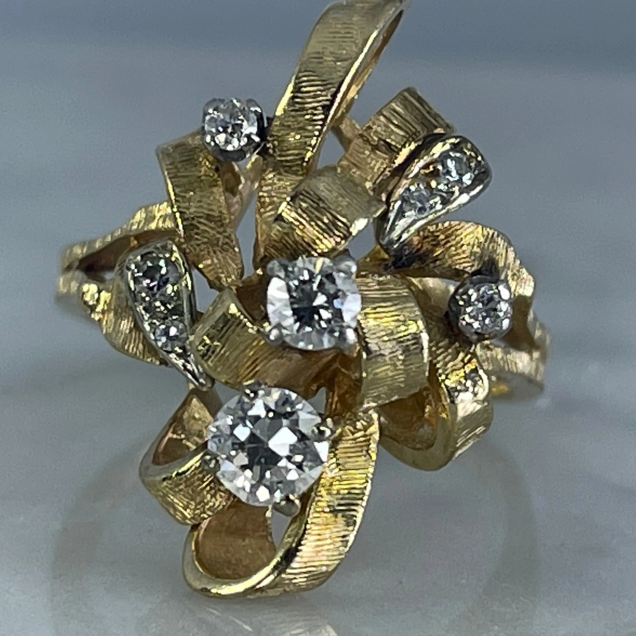 Vintage Diamond Cluster Ring with Old Hollywood Glamour. 14K Yellow Gold Setting with a Ribbon Design.