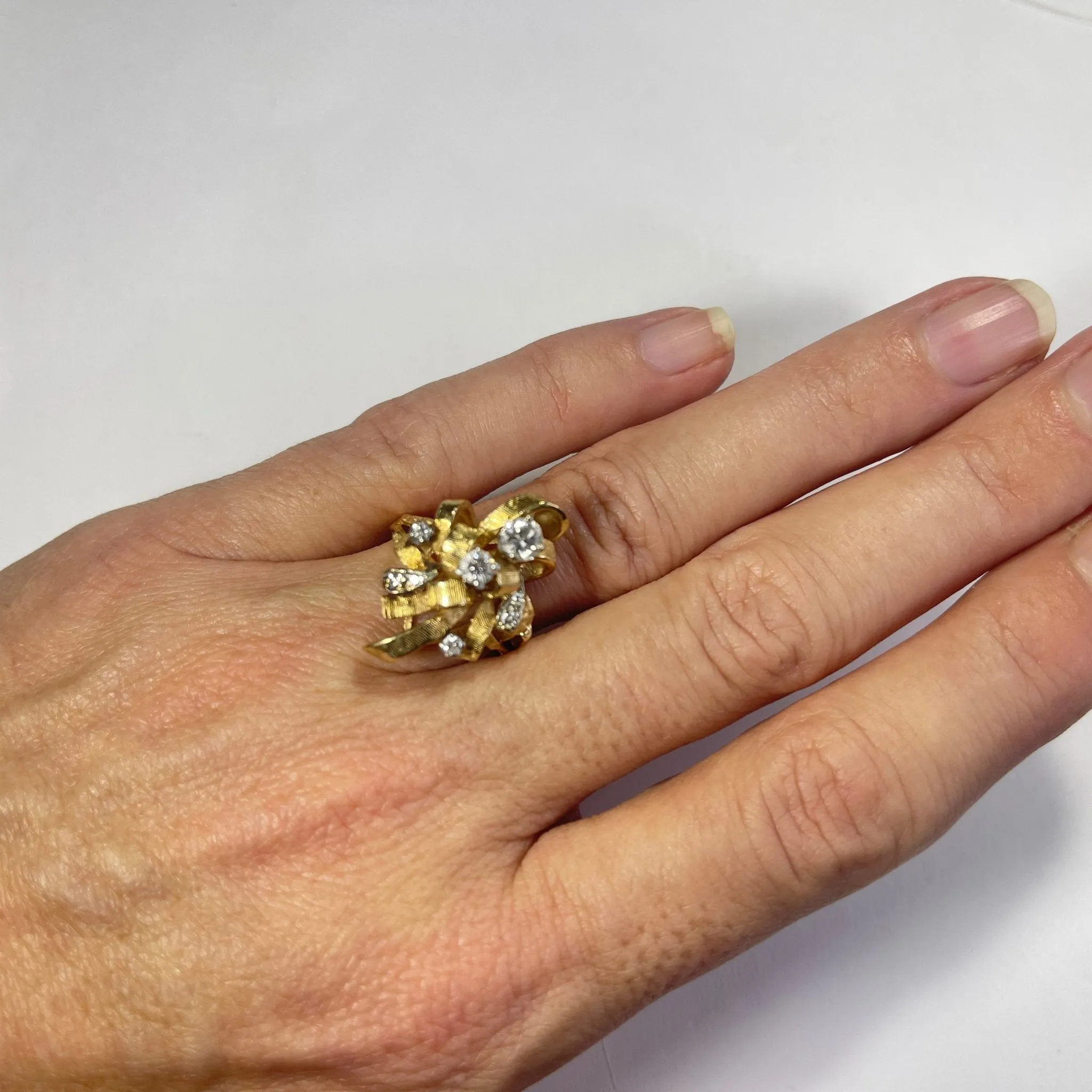 Vintage Diamond Cluster Ring with Old Hollywood Glamour. 14K Yellow Gold Setting with a Ribbon Design.