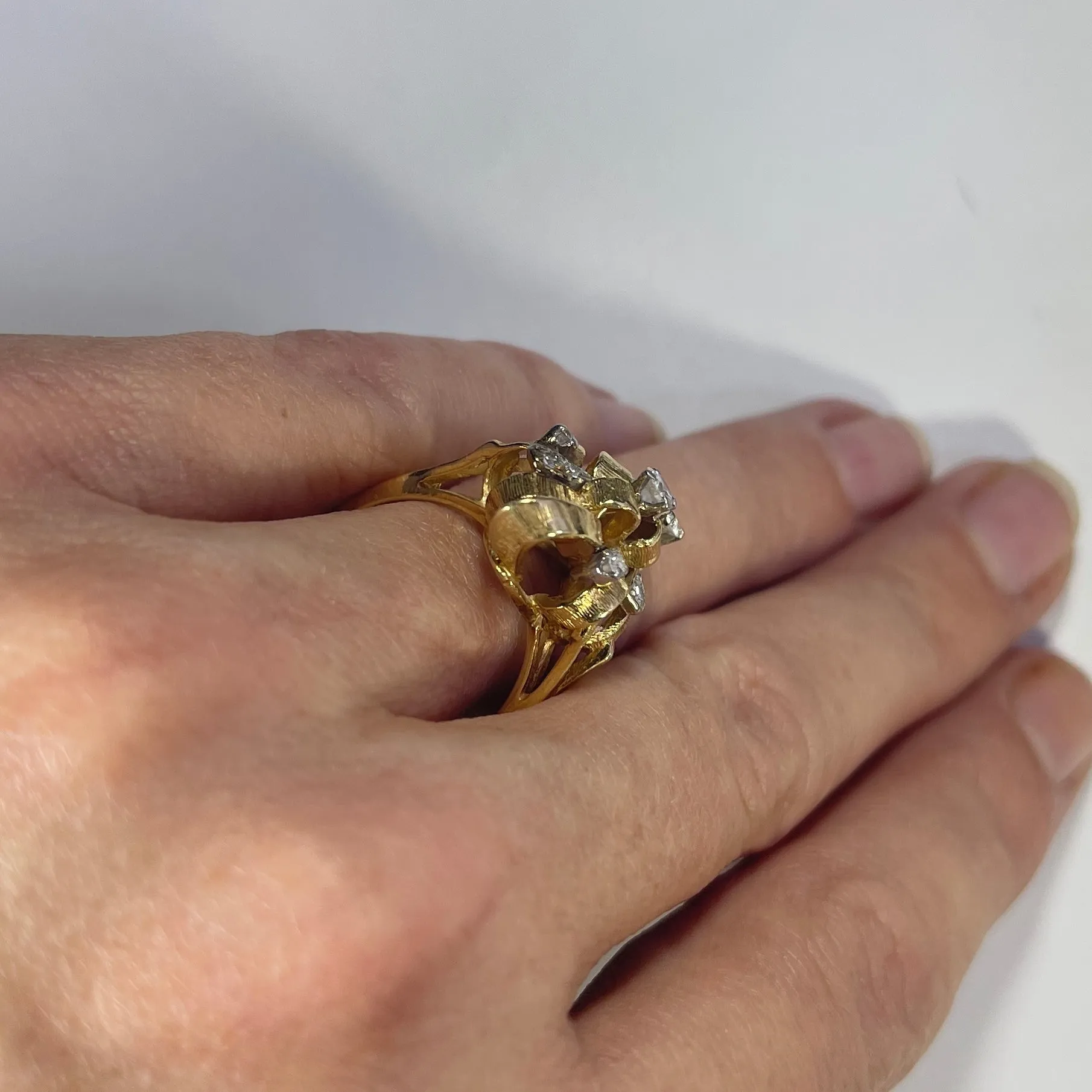 Vintage Diamond Cluster Ring with Old Hollywood Glamour. 14K Yellow Gold Setting with a Ribbon Design.