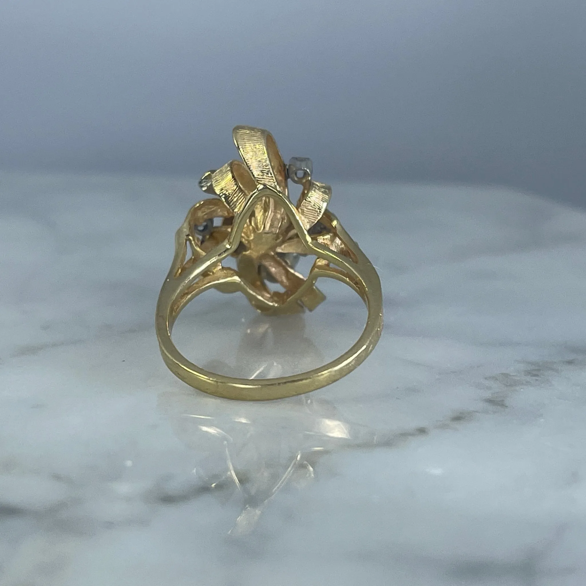 Vintage Diamond Cluster Ring with Old Hollywood Glamour. 14K Yellow Gold Setting with a Ribbon Design.