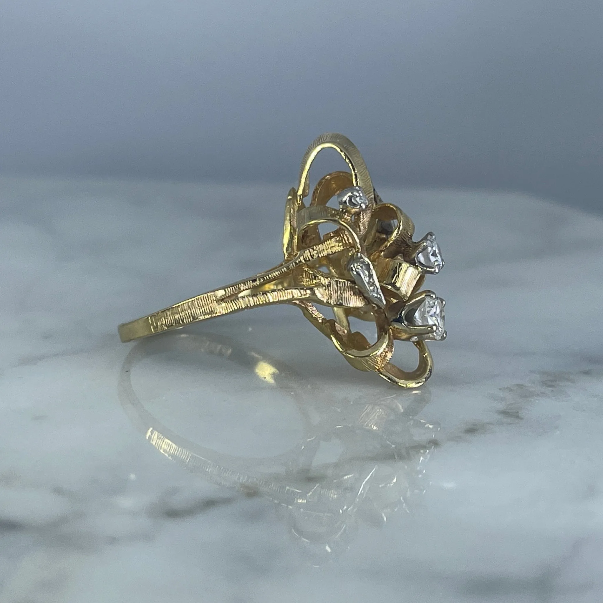 Vintage Diamond Cluster Ring with Old Hollywood Glamour. 14K Yellow Gold Setting with a Ribbon Design.